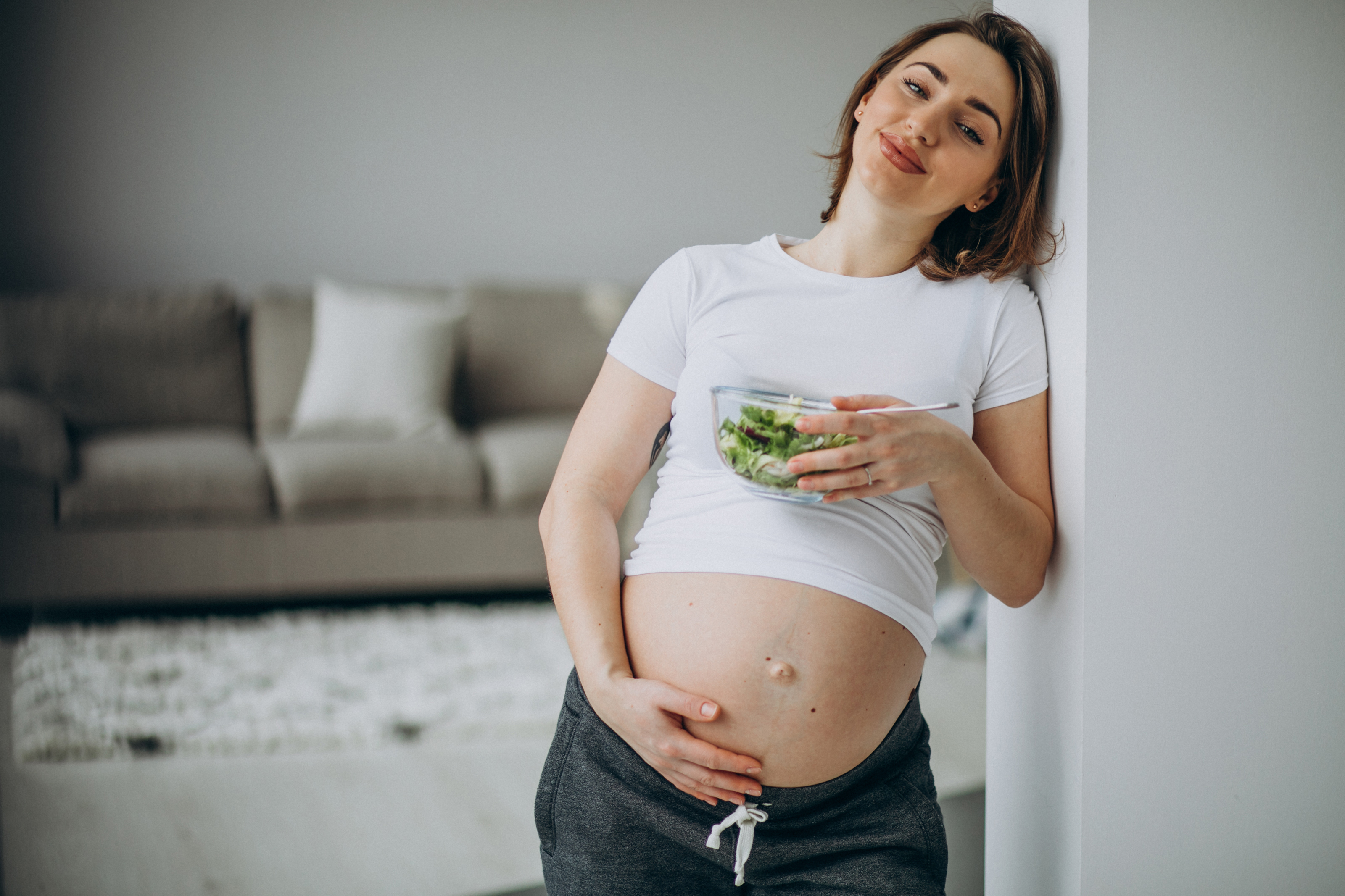joven-embarazada-comiendo-ensalada-casa